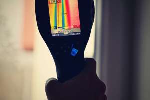 Hand thermal imaging camera to check temperature .